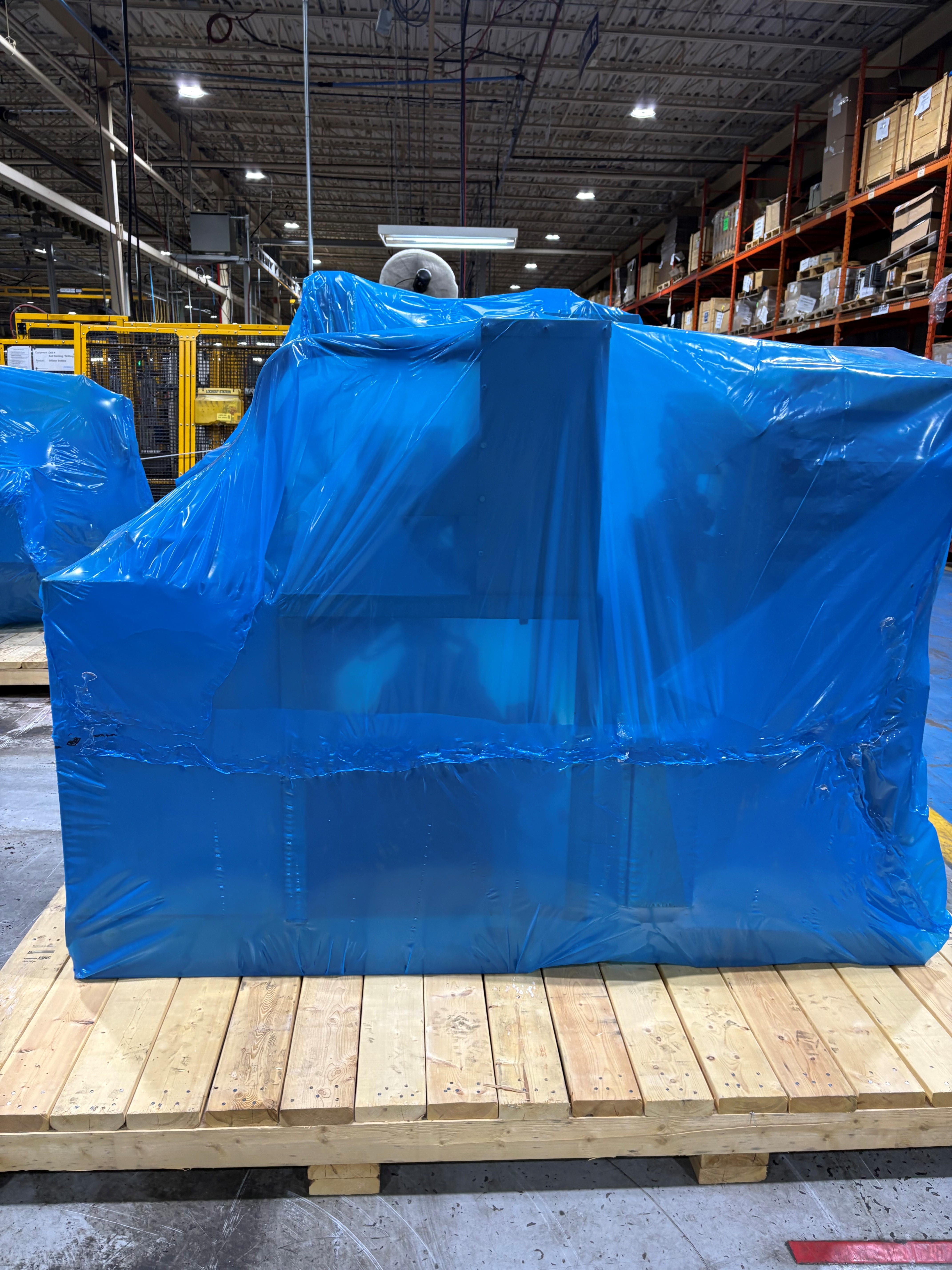 Industrial machine wrapped and palletized for shipment by Bolstyn Packaging Inc in Burlington Ontario warehouse
