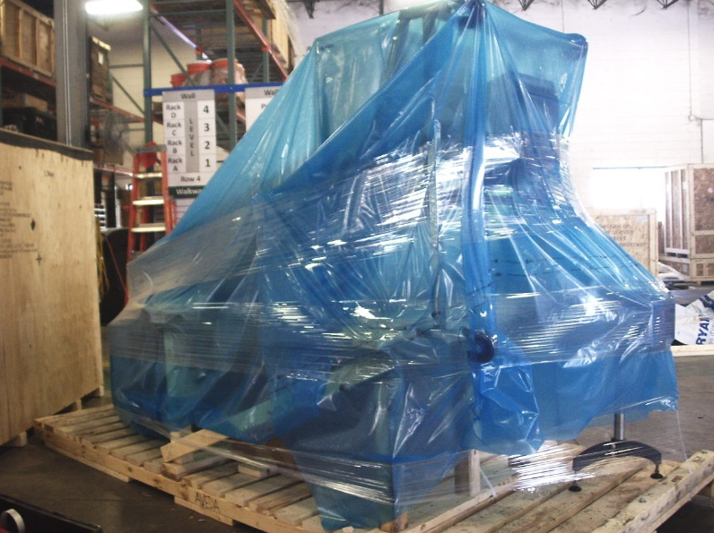 Wrapped industrial equipment staged on a pallet in a Burlington warehouse