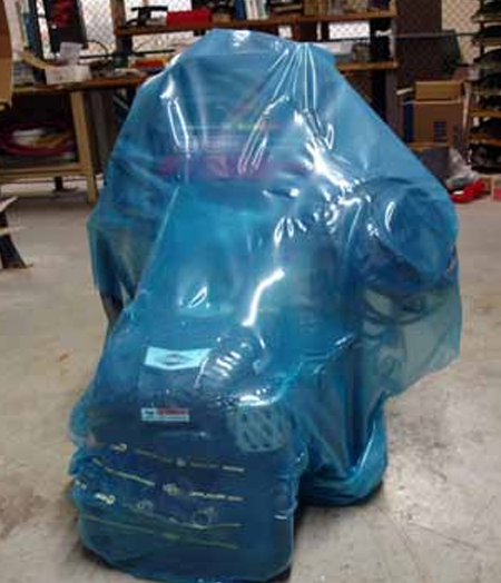 Industrial machine fully wrapped in protective film ready for shipment
